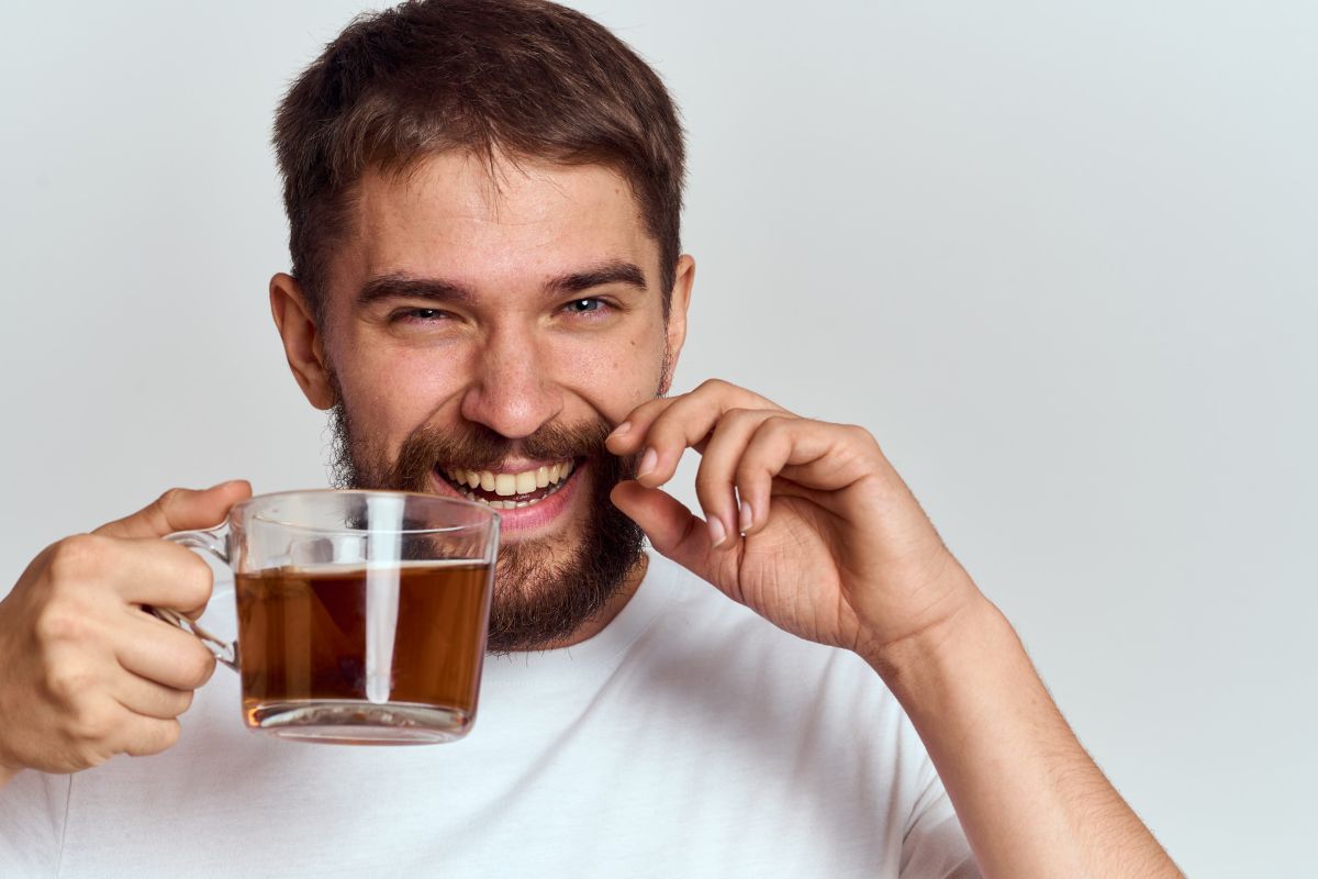 a-happy-man-with-a-mustache-and-a-beard-holds-a-